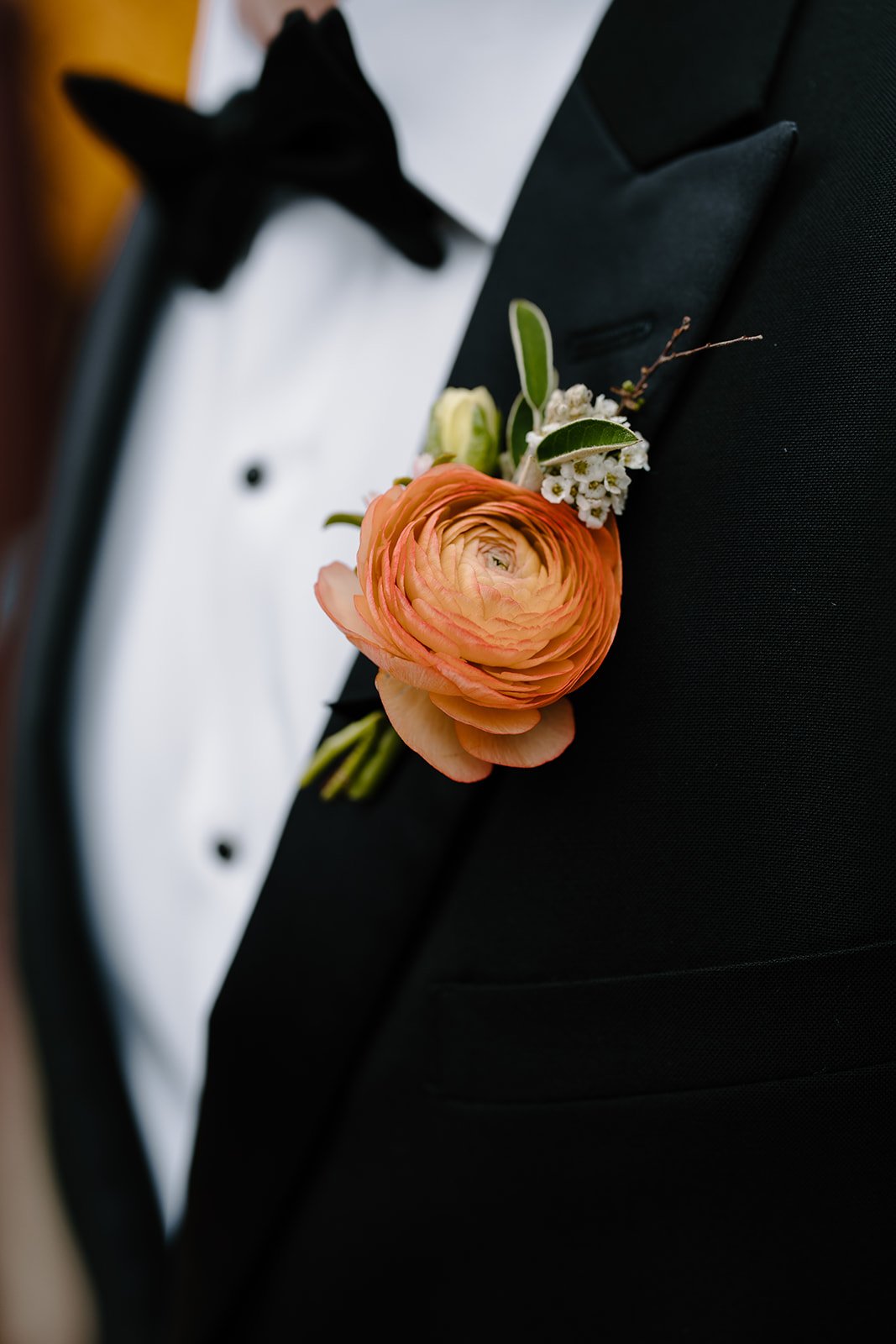 Orange ranunculus boutonniere
