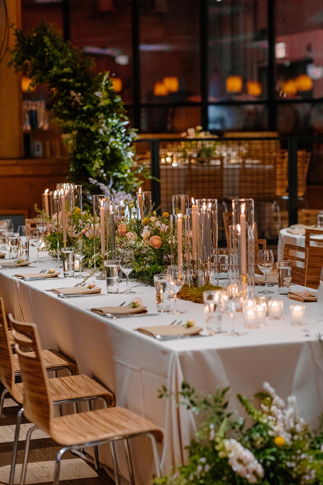 Greenery and candlelight reception setting